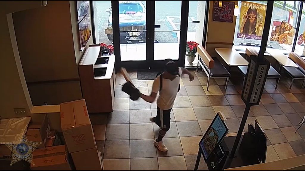 Man accused of damaging kiosks, cars at Taco Bell