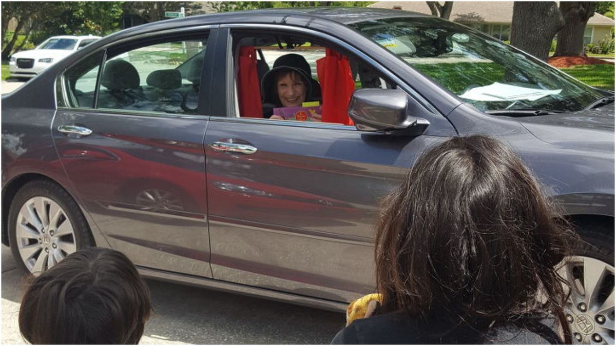 Coronavirus: Florida woman practices social distancing while reading to grandchildren from her car