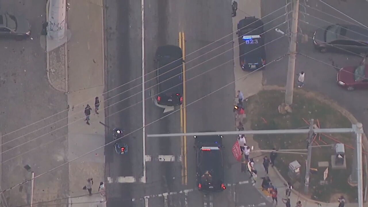 Trump's motorcade is greeted by people as it leaves the Fulton County Jail
