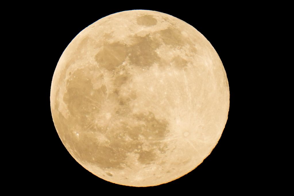 Photos: Super Pink Moon, April's full moon, brightens the night sky