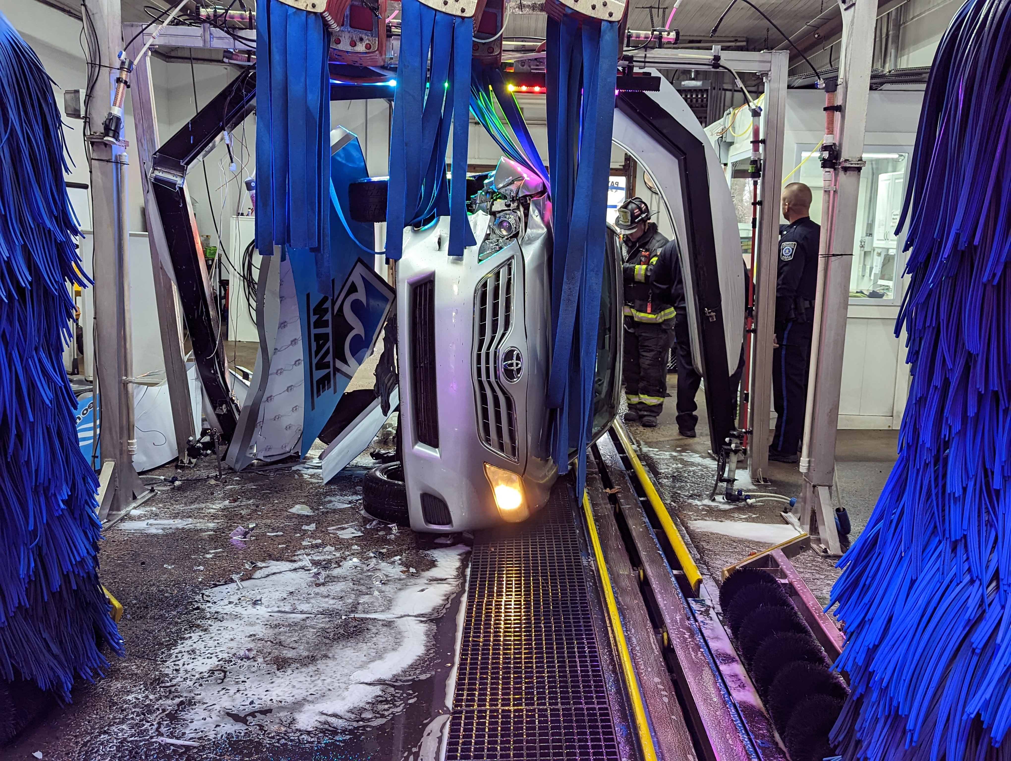 Driver rescued after car flips inside car wash