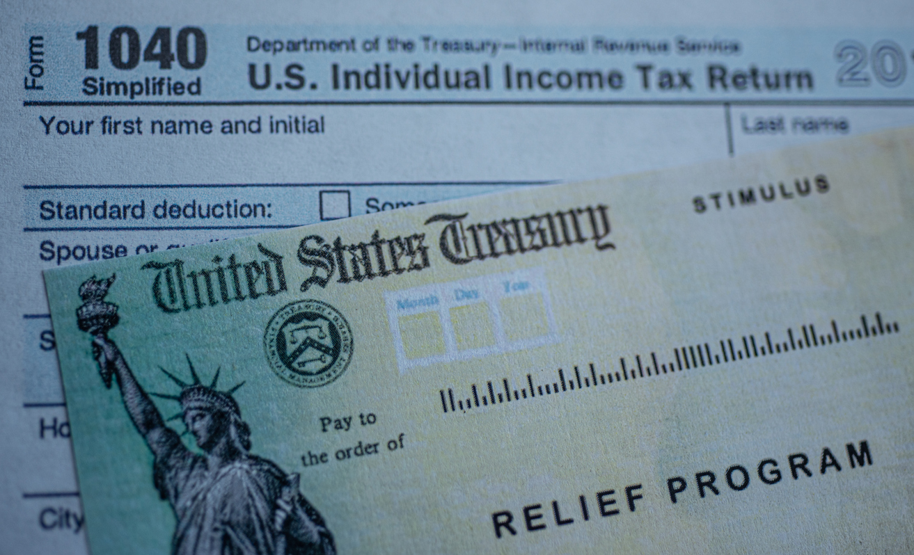 Form 1040 U.S. Individual Income tax return next to the Stimulus Check Relief program. Close up view.