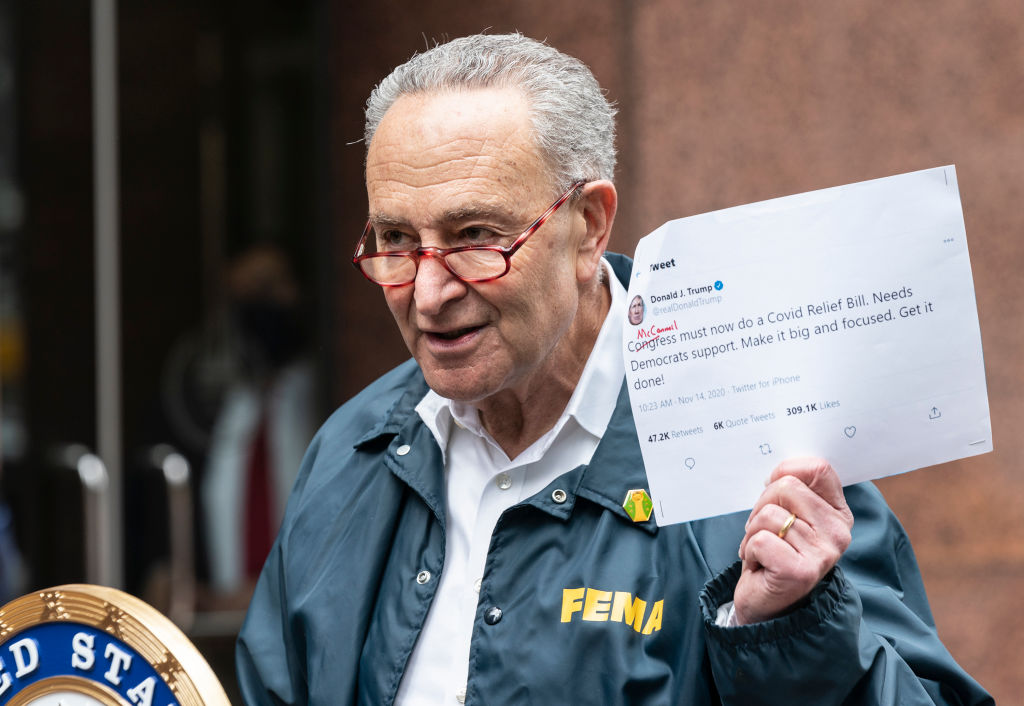 U.S. Senator Chuck Schumer holding printout tweet by