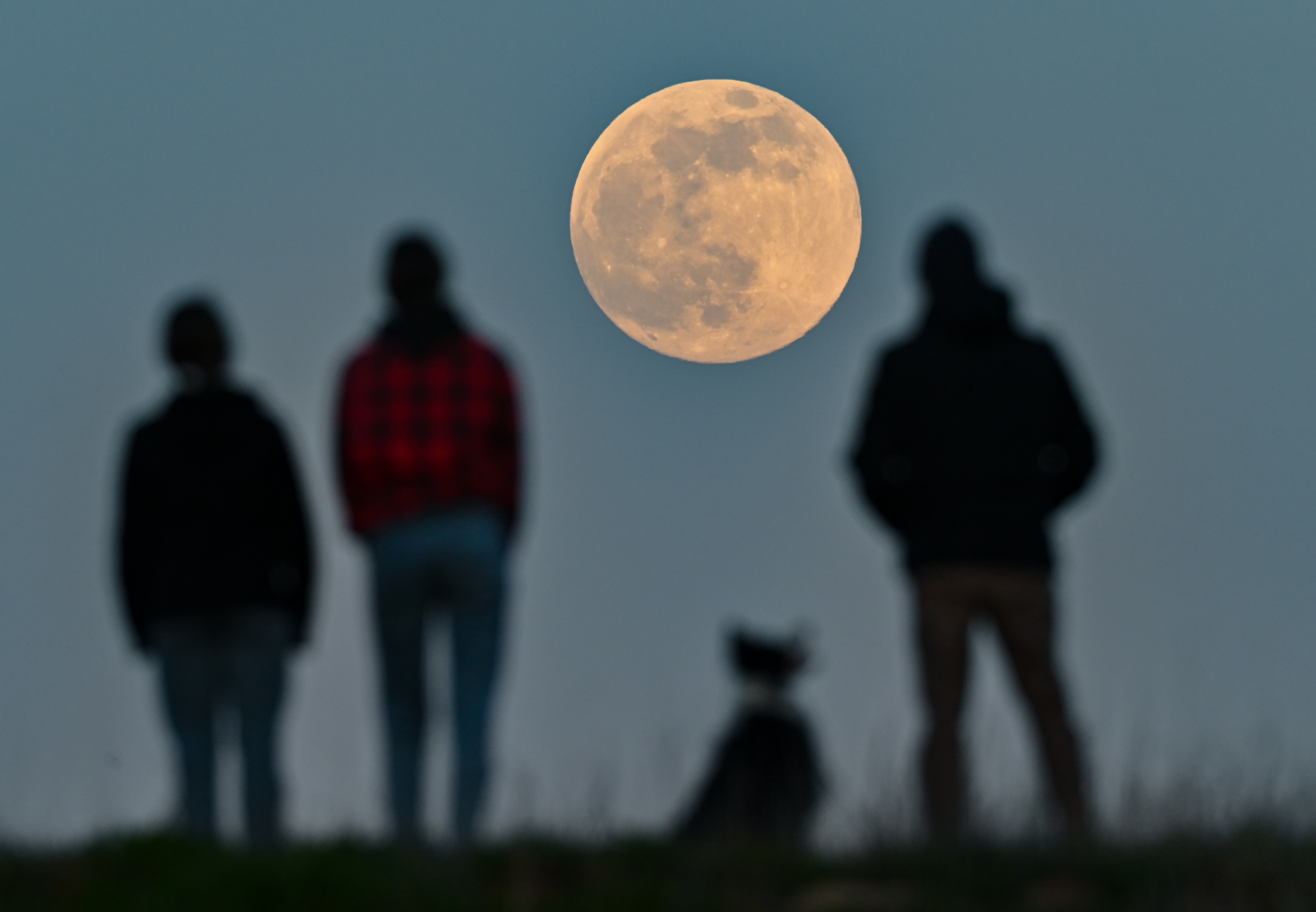 Photos: Super Pink Moon, April's full moon, brightens the night sky