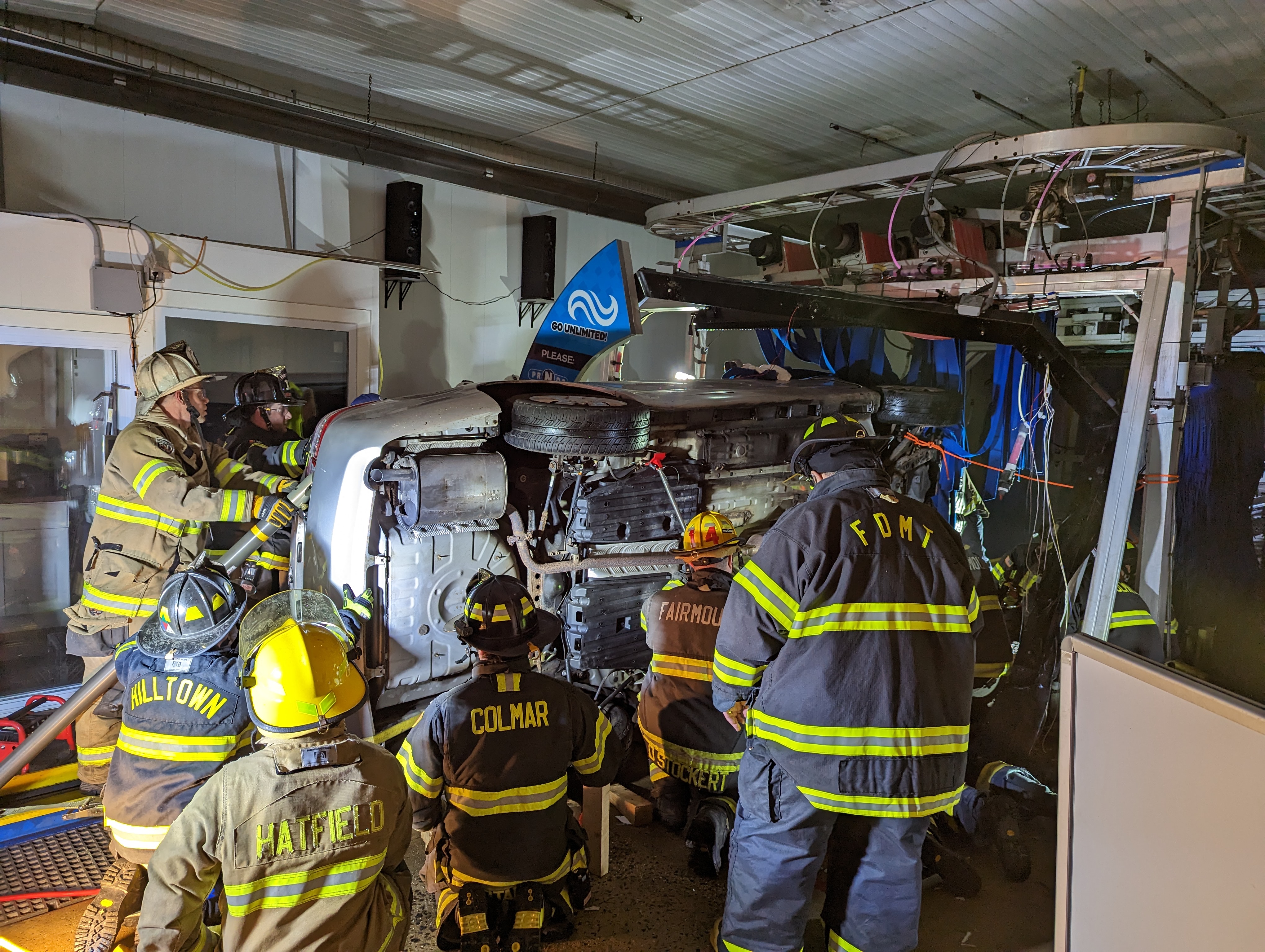 Driver rescued after car flips inside car wash
