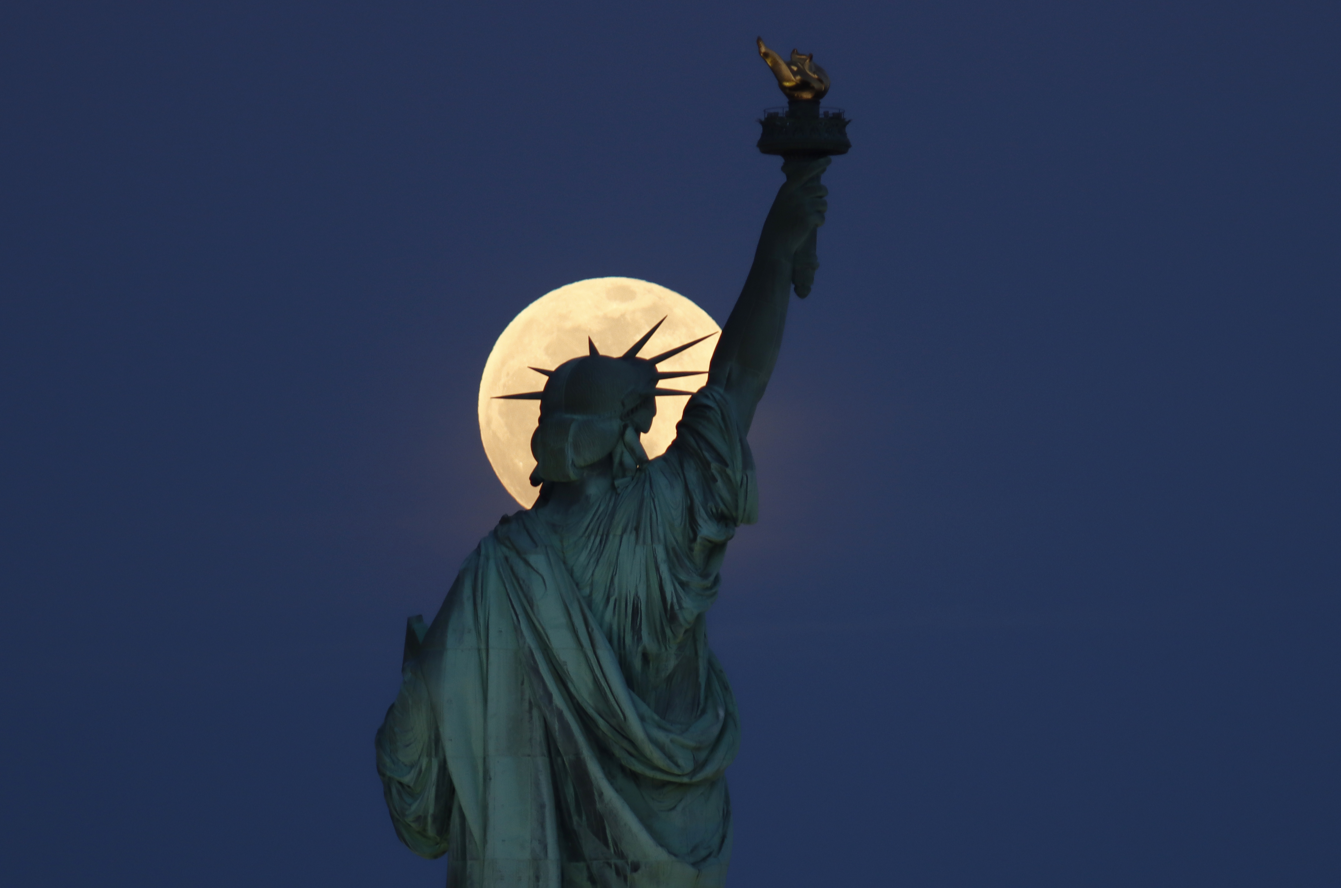 Photos: Super Pink Moon, April's full moon, brightens the night sky