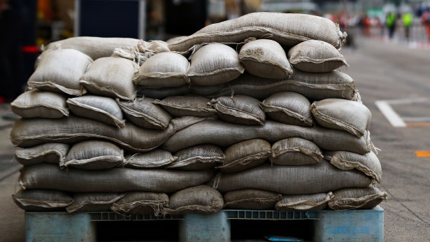 Driver injured after man throws sandbags