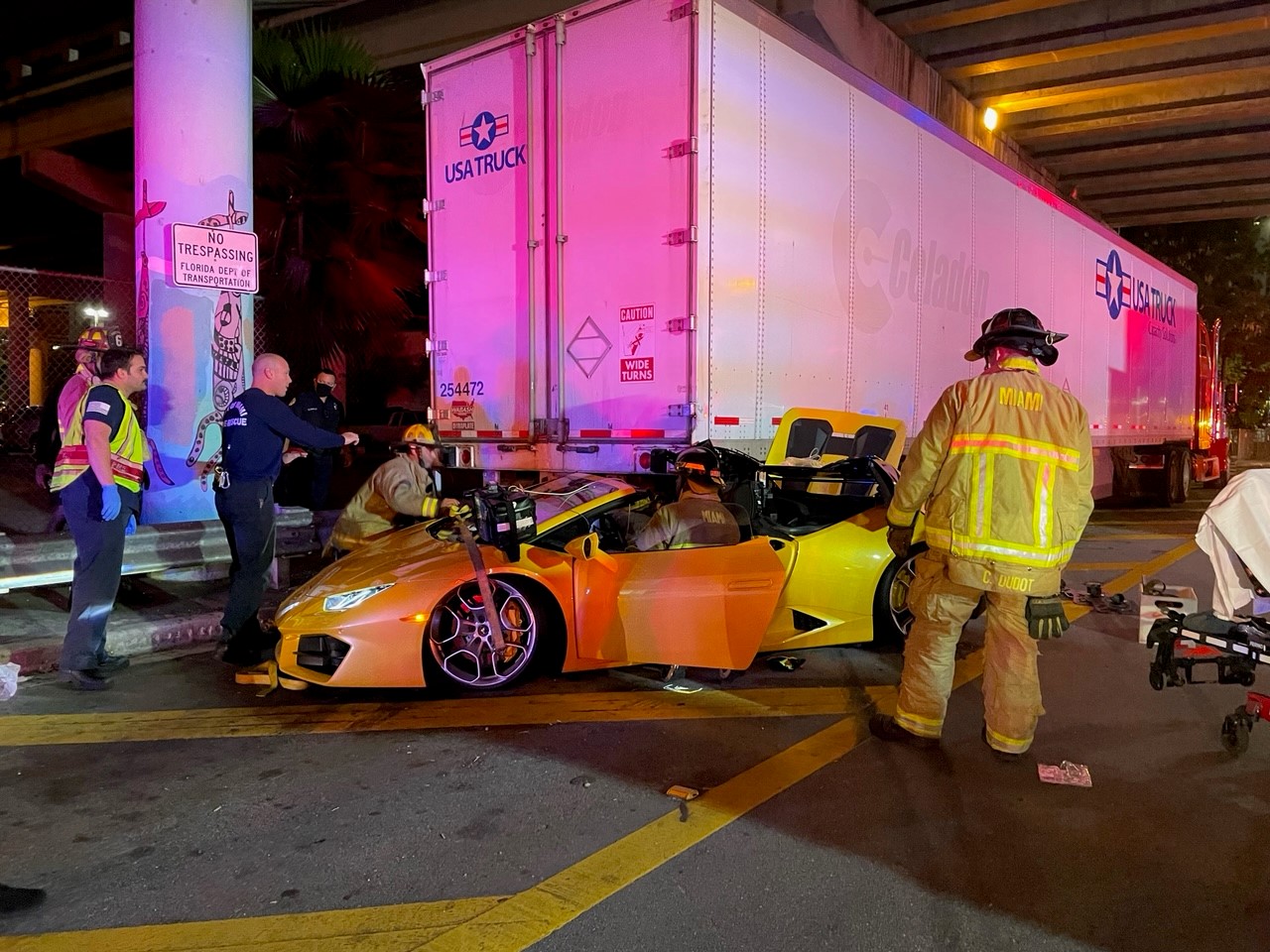 Crash leaves Lamborghini stuck under truck