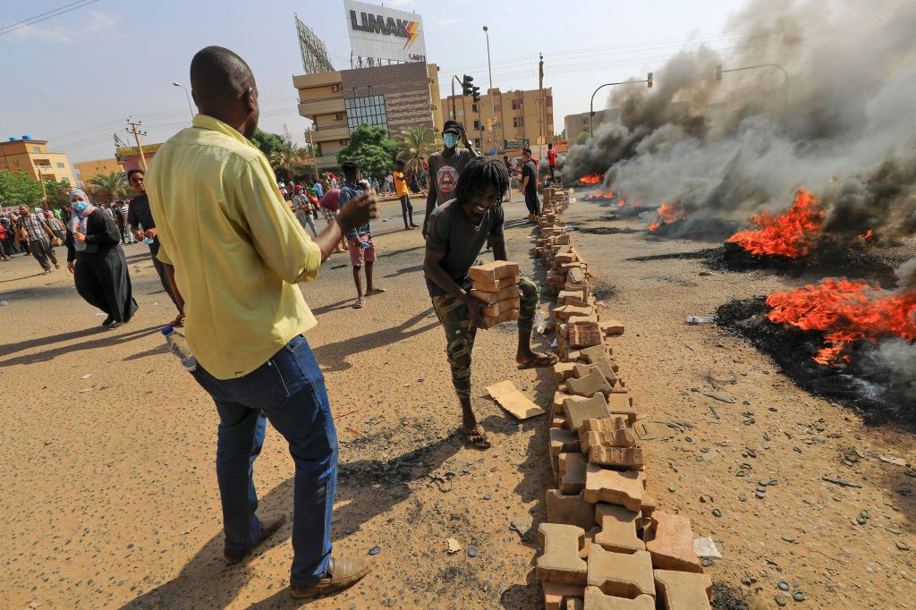 Photos: Sudanese protesters flood streets amid reports of possible military coup