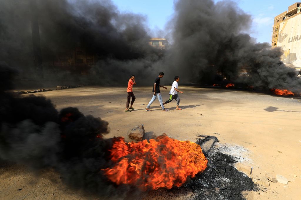 Photos: Sudanese protesters flood streets amid reports of possible military coup