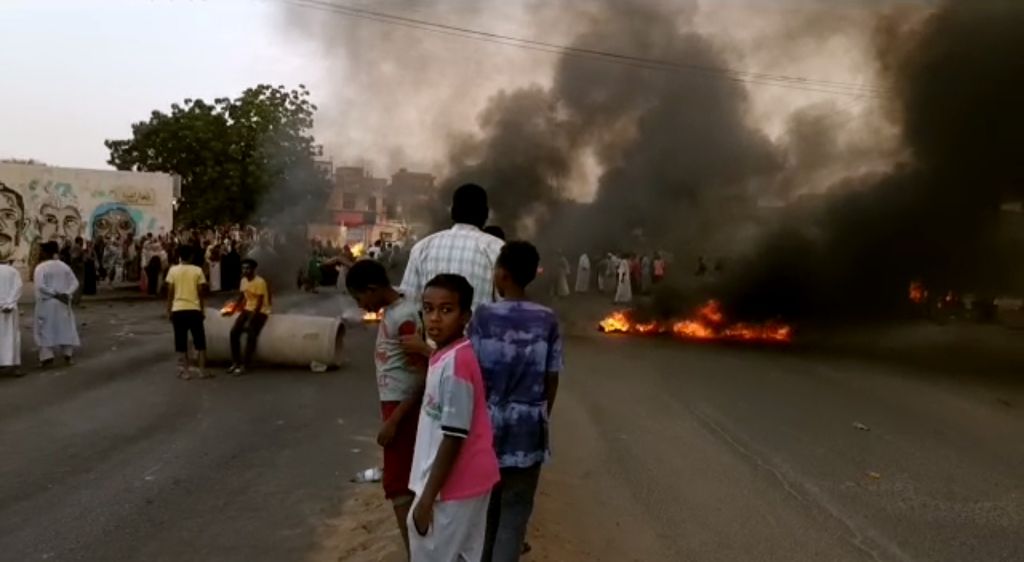 Photos: Sudanese protesters flood streets amid reports of possible military coup