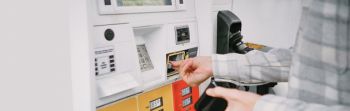 Man Purchases Gas at Pump