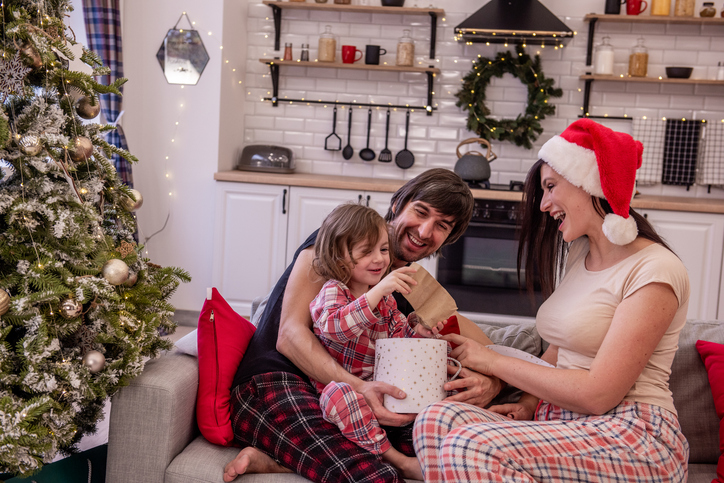 Family Unwrapping Christmas Gifts Together