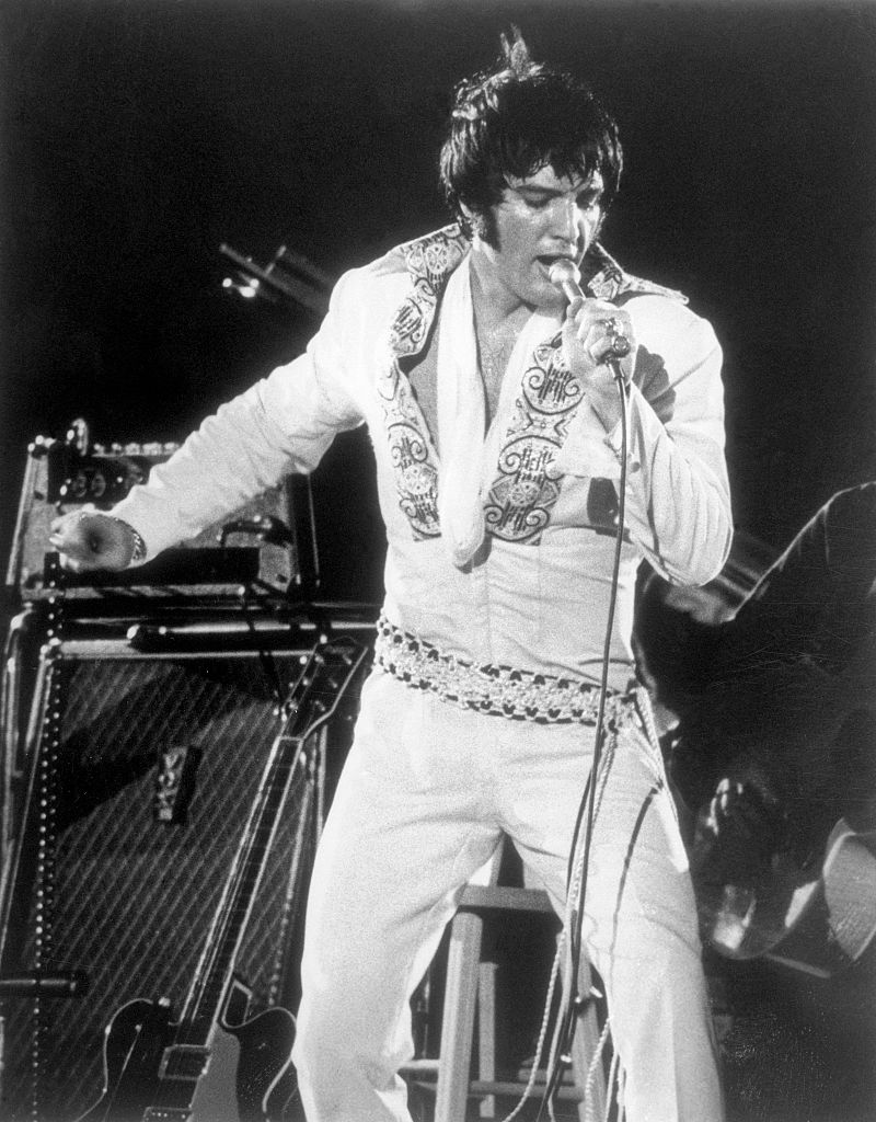 Elvis in Costume and Singing into Microphone