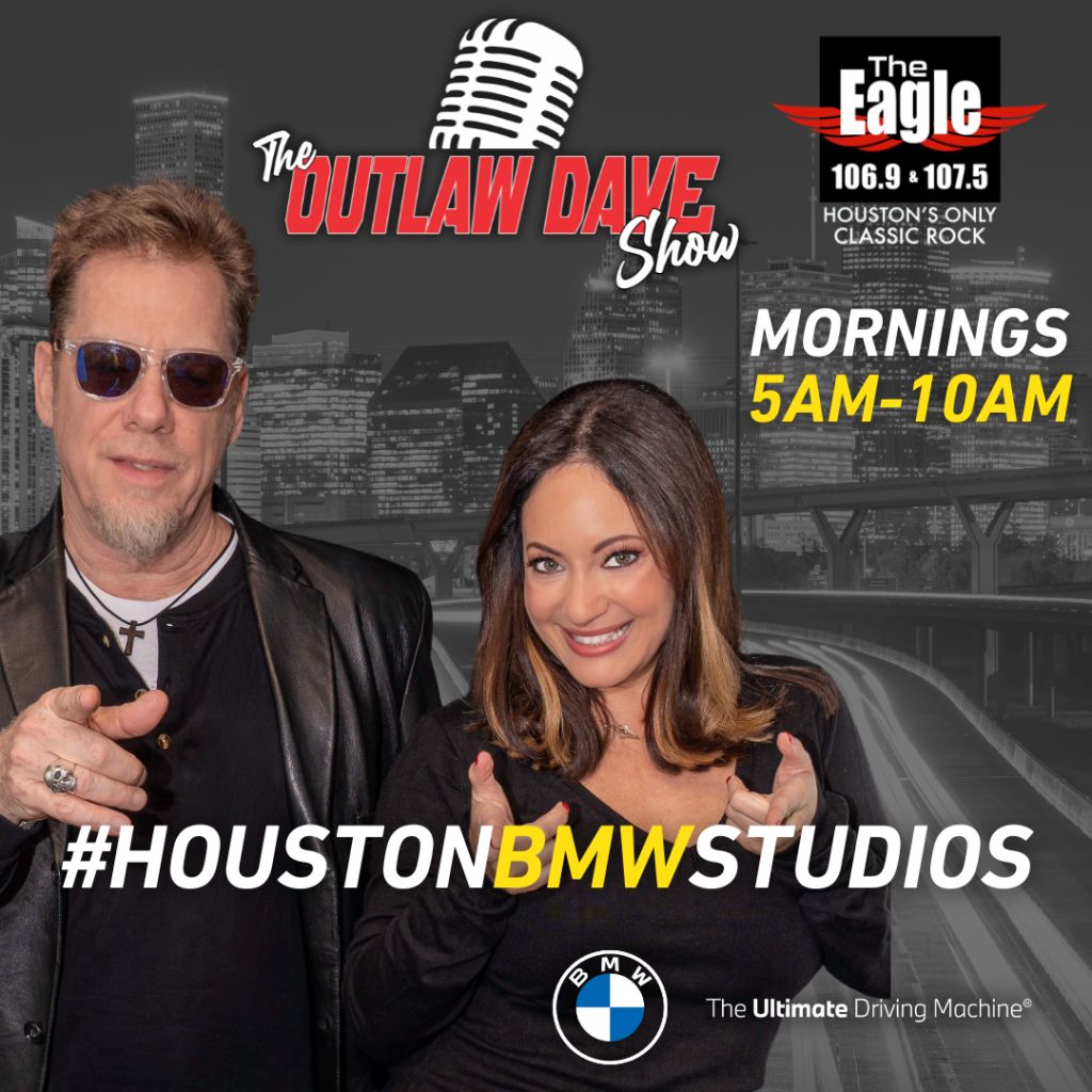 Two radio personalities posing in front of a cityscape, with the logo and branding for "The Outlaw Dave Show" and "The Eagle 106.9 & 107.5" radio stations.
